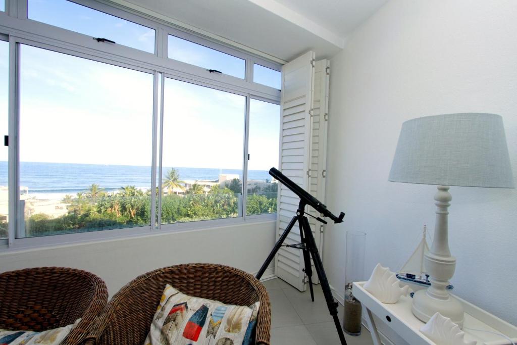 a room with a view of the ocean and a telescope at 34 Sea Lodge - by Stay in Umhlanga in Durban