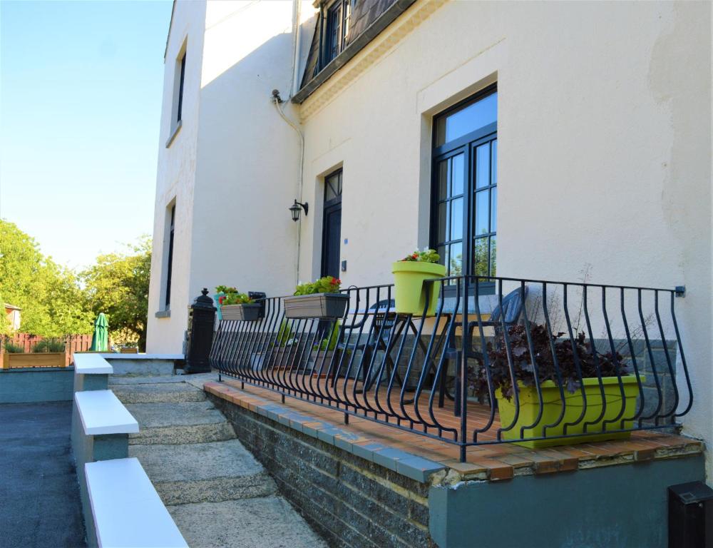 a balcony of a house with a window and benches at La Lunadeléo in Wépion