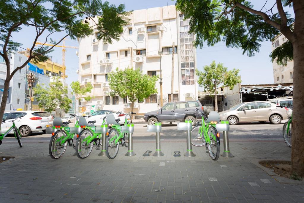 a group of bikes parked on a sidewalk at Nahalat Yehuda Residence in Tel Aviv