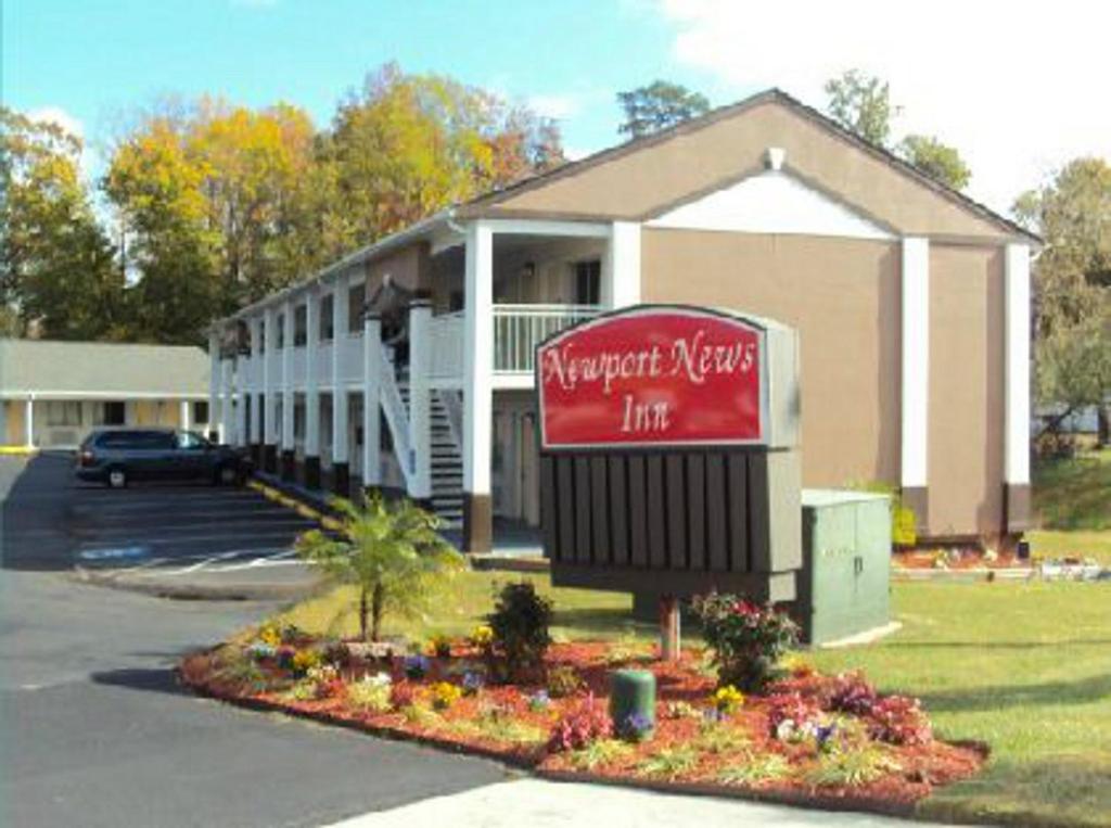 a building with a sign in front of it at Newport News Inn in Newport News