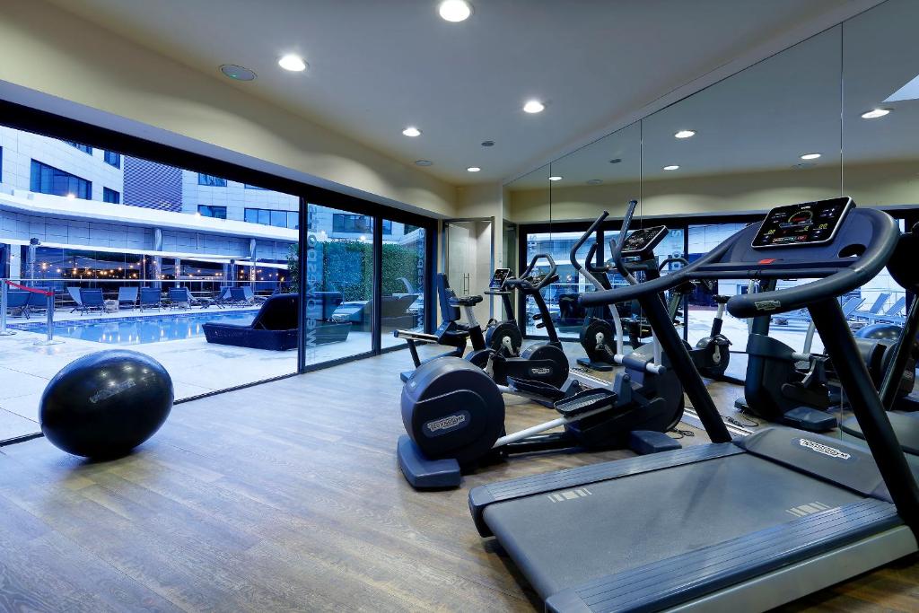 a gym with treadmills and ellipticals in a building at Hotel SB Icaria in Barcelona