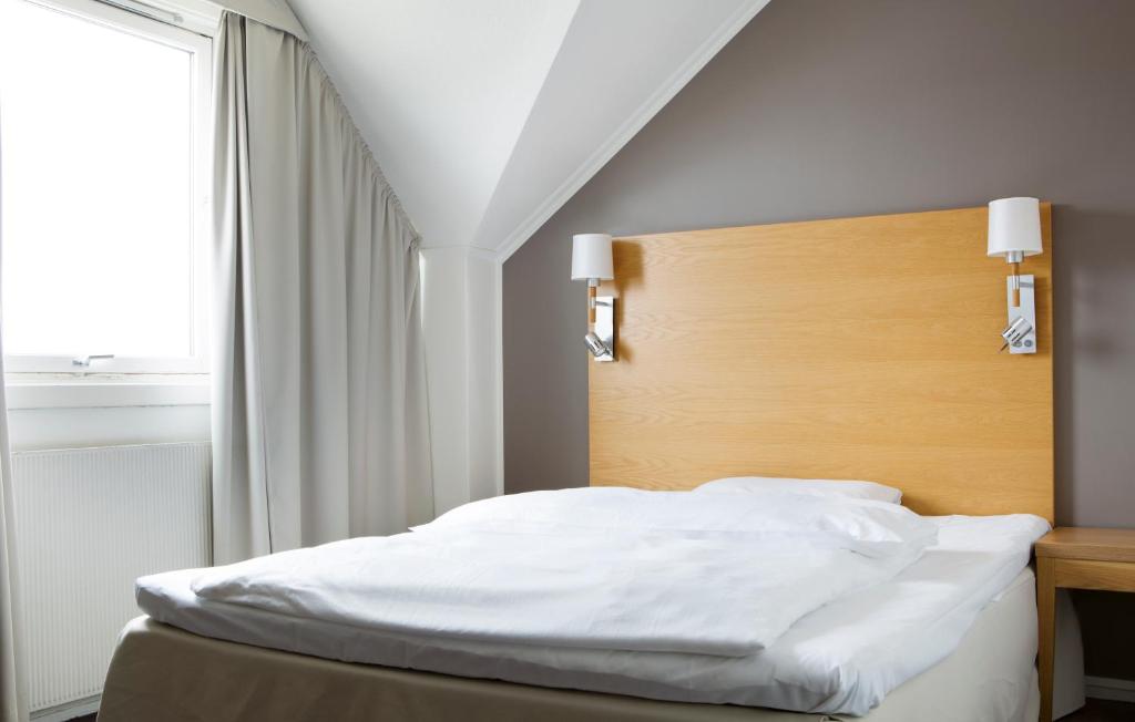 En eller flere senger på et rom på Comfort Hotel Fosna