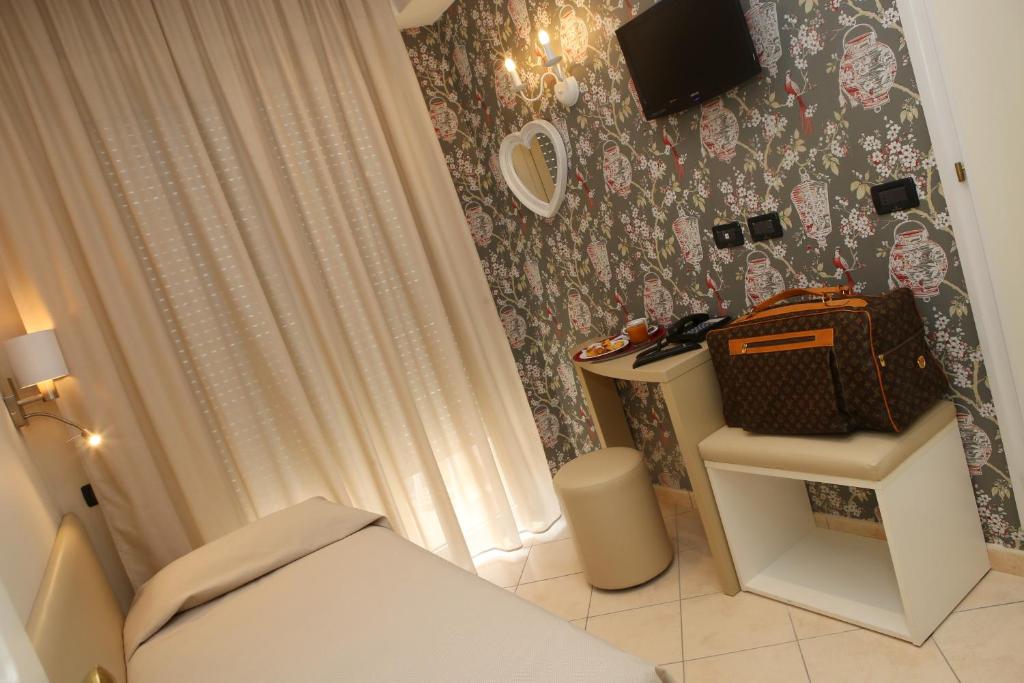 Postel nebo postele na pokoji v ubytování Hotel Piccinelli