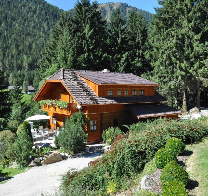 ein großes Holzhaus mitten im Wald in der Unterkunft Chalet Styria in Donnersbachwald