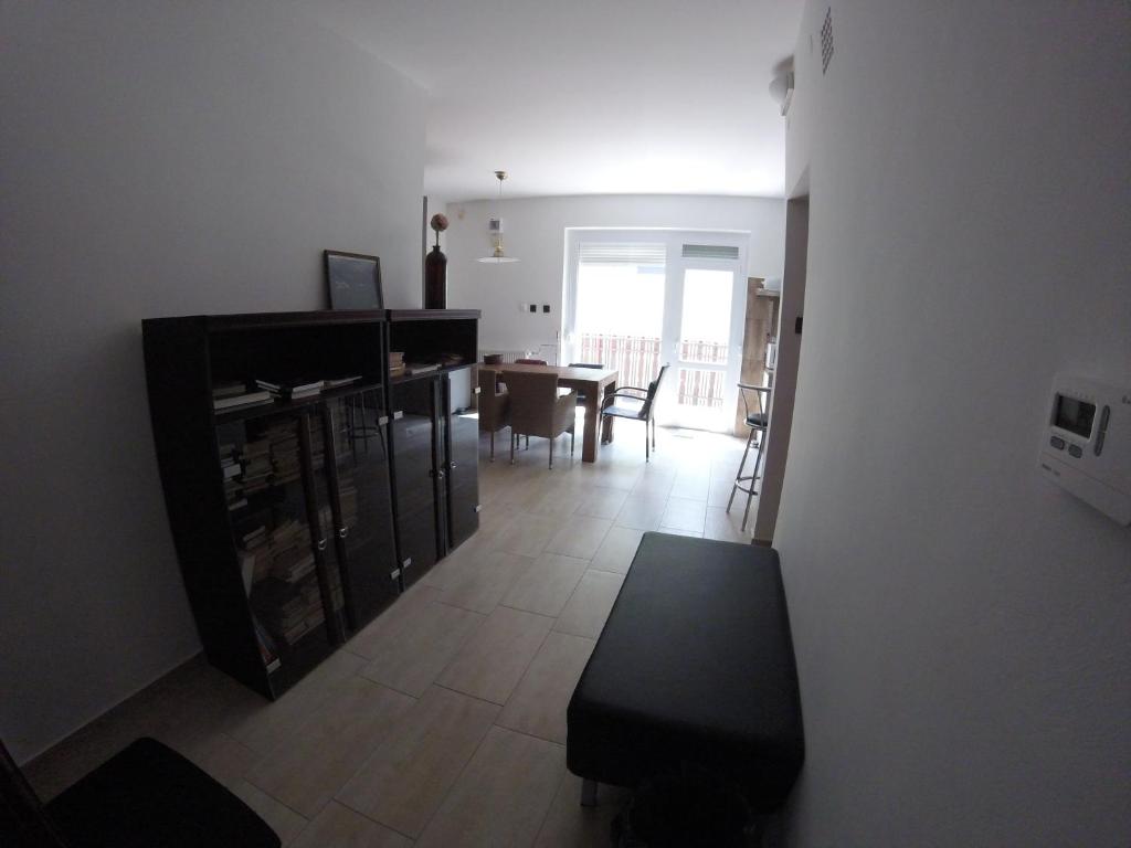 a living room with a table and a dining room at Dózsaház in Zalaegerszeg