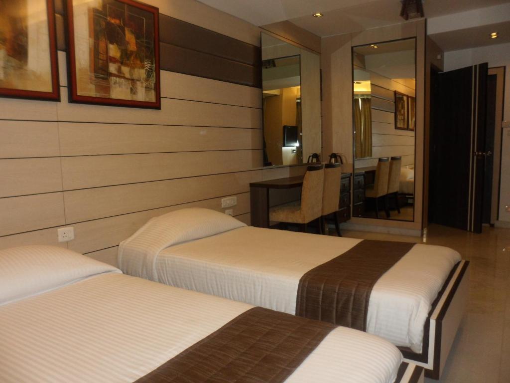 Postel nebo postele na pokoji v ubytování Hotel Esteem