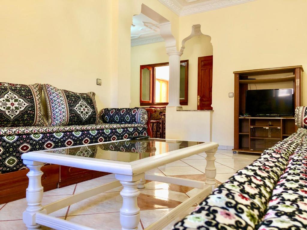a living room with a couch and a coffee table at Dar Rachid in Asilah
