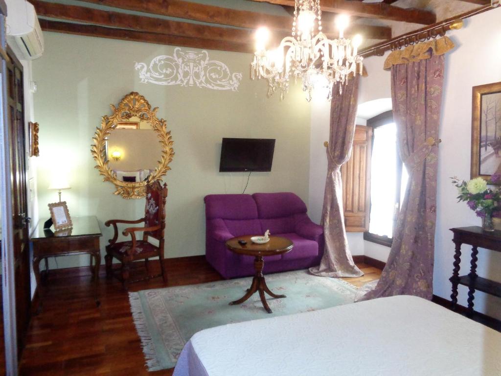 Postel nebo postele na pokoji v ubytování Hotel Boutique Nueve Leyendas