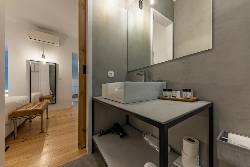 a kitchen with a sink and a counter top at Sapientia Boutique Hotel in Coimbra