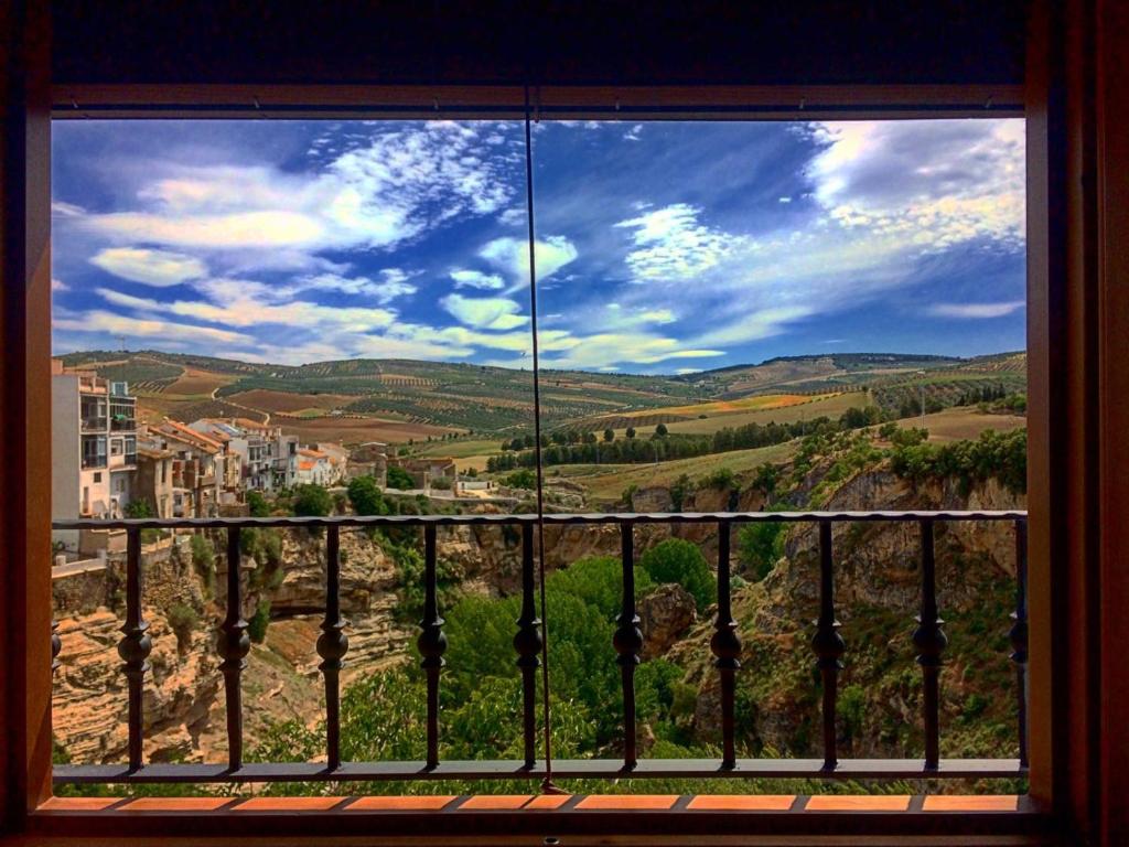 a window with a view of the countryside at La Maroma Rooms & Views in Alhama de Granada