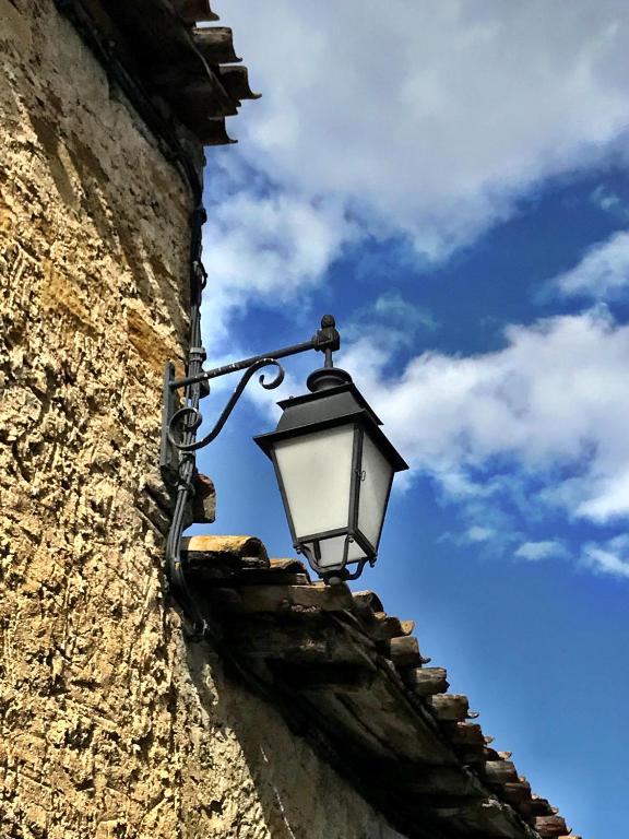 a street light on the side of a building at Maison Marie in Lagarde