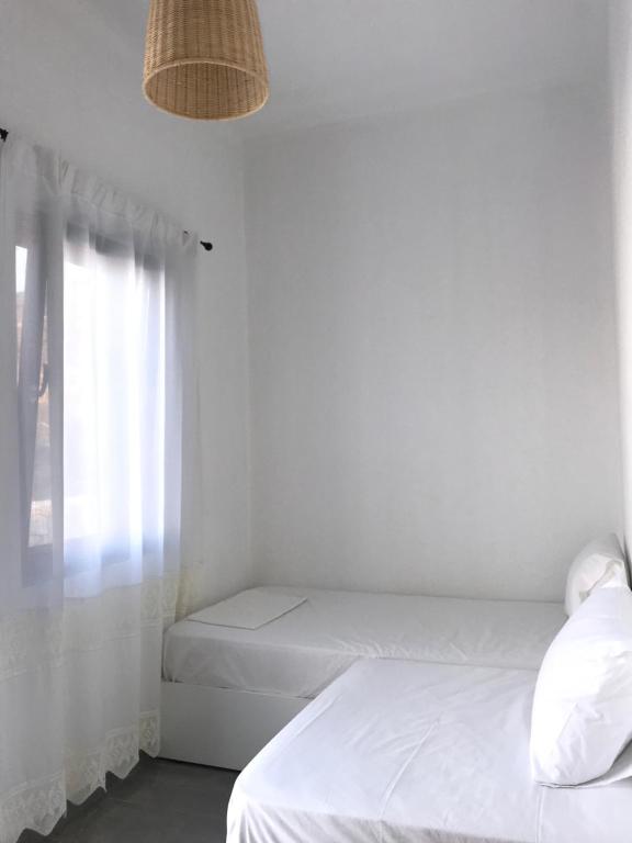 Postel nebo postele na pokoji v ubytování Vegera Beach House, Donoussa