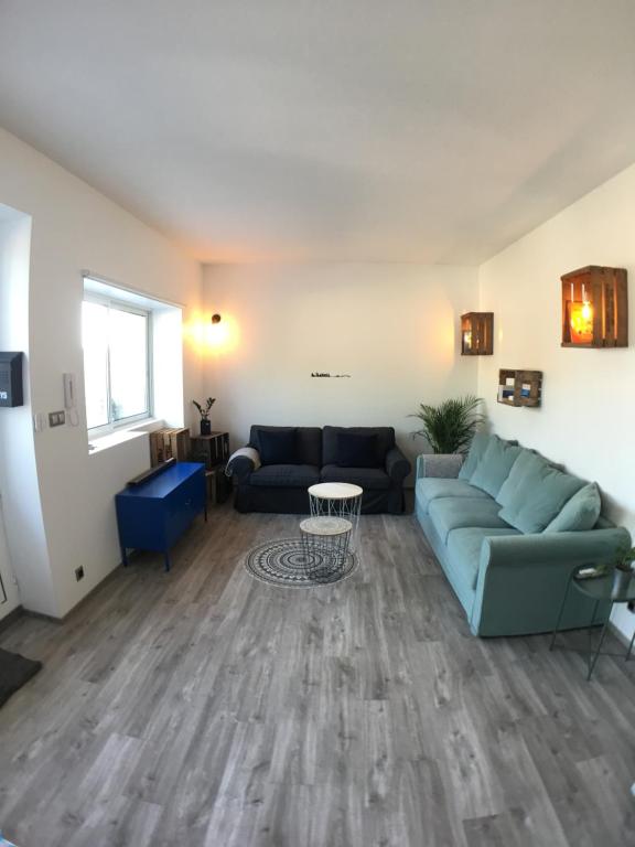 a living room with a couch and a table at SunRise Cassis in Cassis