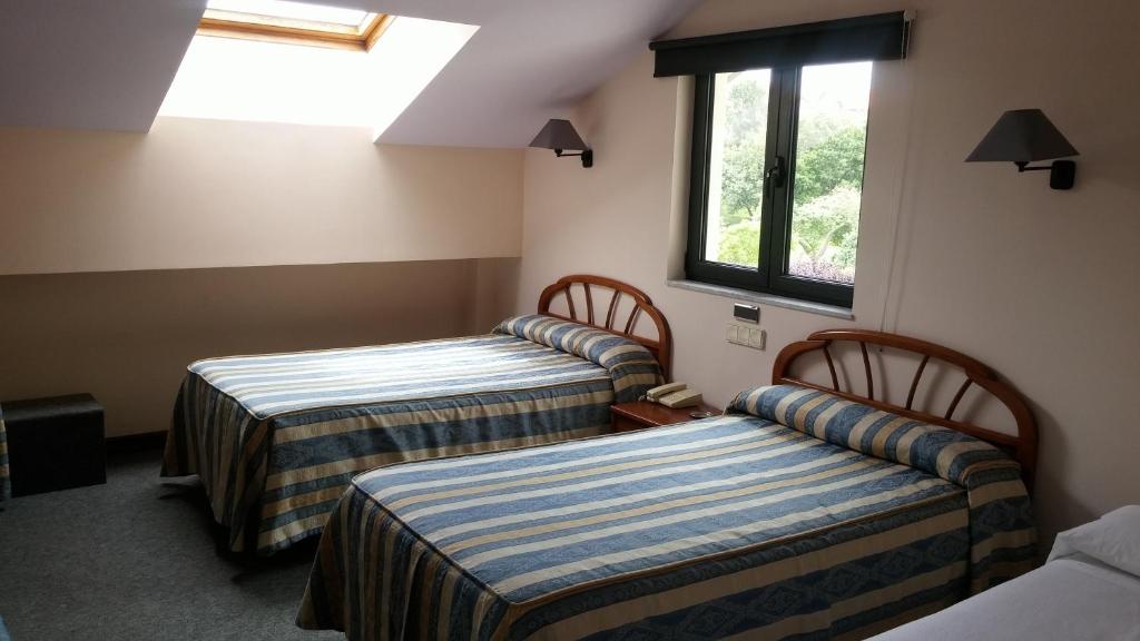 A bed or beds in a room at Hotel Zabala