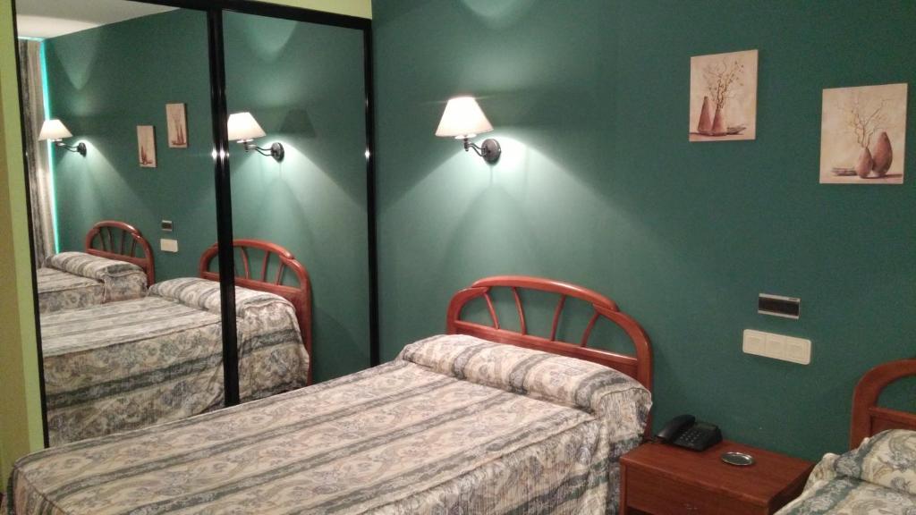 A bed or beds in a room at Hotel Zabala