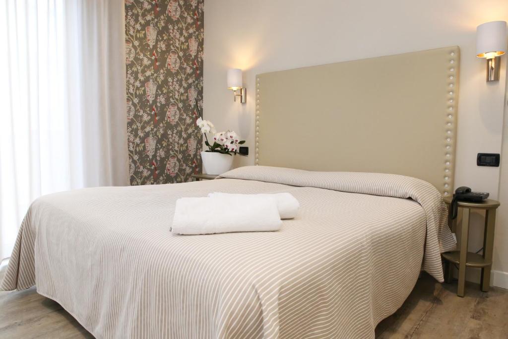 Postel nebo postele na pokoji v ubytování Hotel Piccinelli
