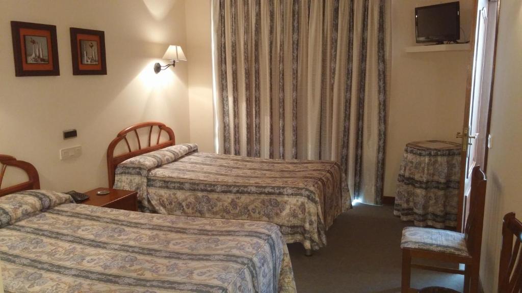A bed or beds in a room at Hotel Zabala