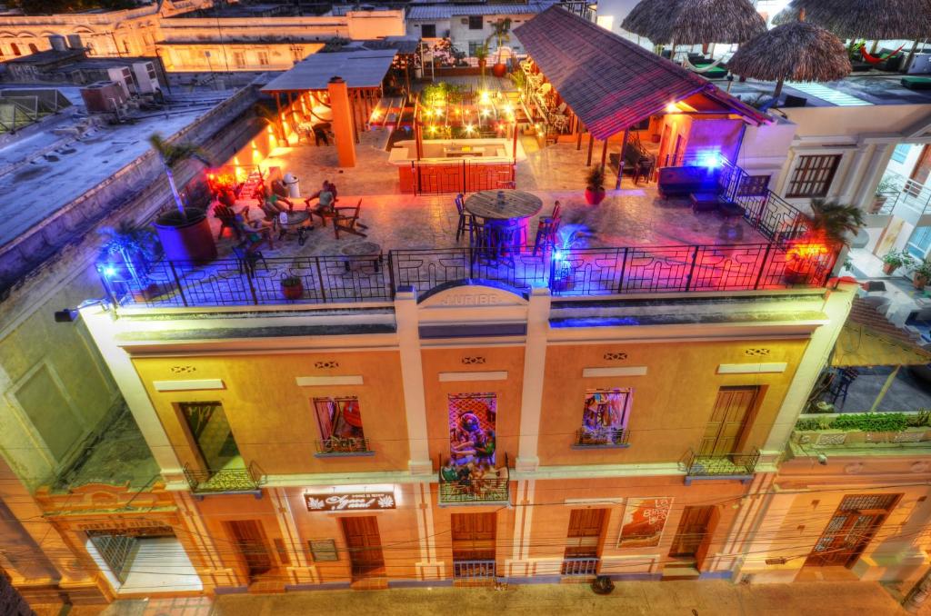 an overhead view of a building with people on a balcony at La Brisa Loca Hostel in Santa Marta