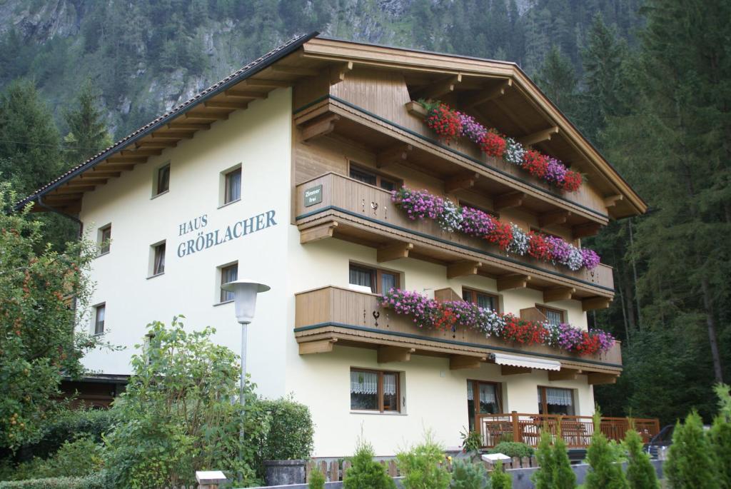 a building with flowers on the side of it at Haus Gröblacher in Mayrhofen