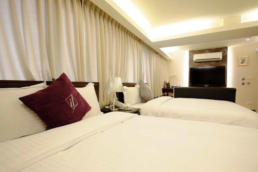 Postel nebo postele na pokoji v ubytování 意芙旅店 Ifinn Hotel
