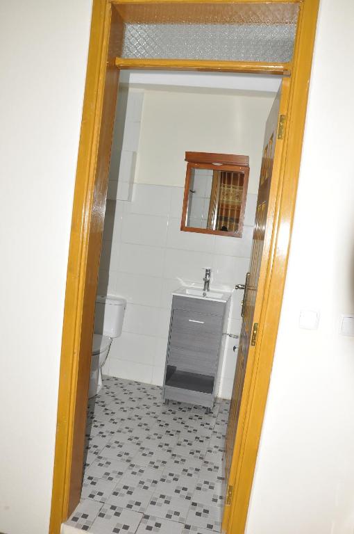a bathroom with a sink and a mirror at Mekelle Hotel in Mekʼelē