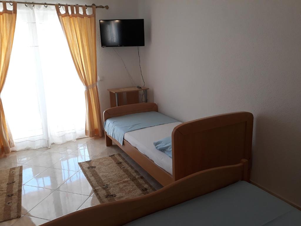 Postel nebo postele na pokoji v ubytování Apartmani Tanja