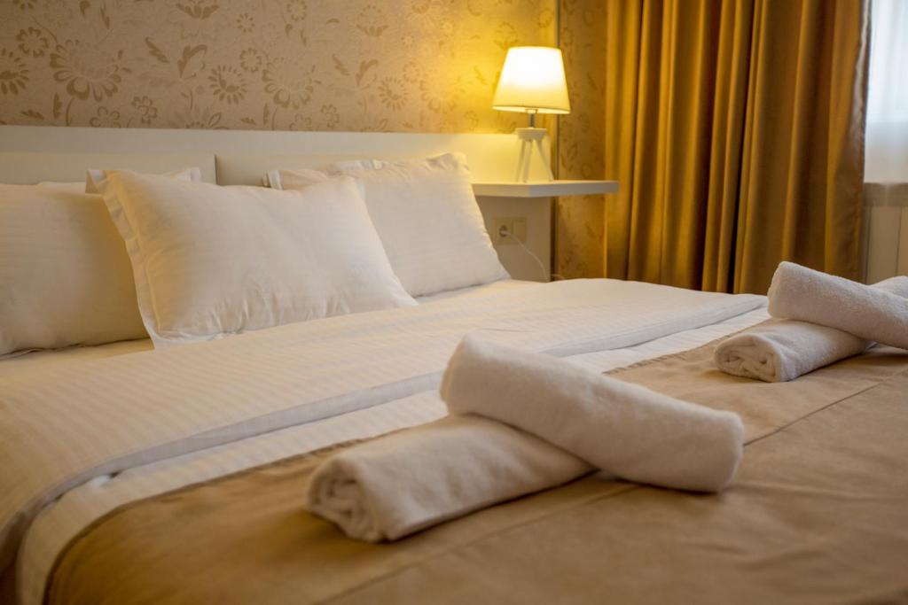 Krevet ili kreveti u jedinici u objektu Otiums Hotel