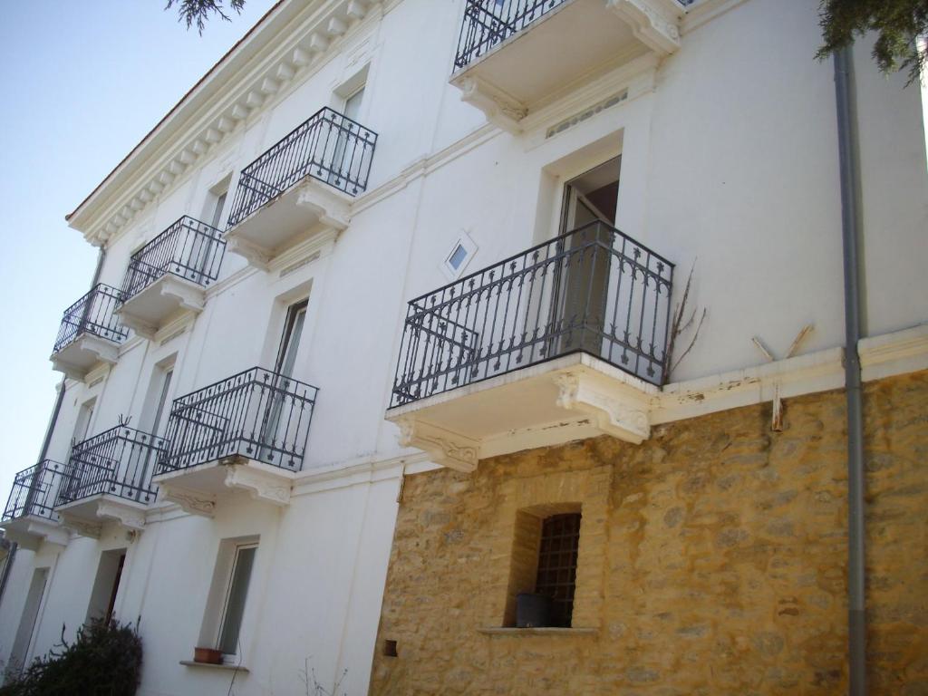 a white building with balconies on the side of it at Villa Muchiarelli in Crecchio