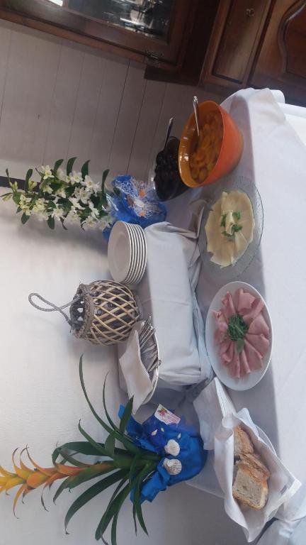 a table with plates of food on top of it at Hotel Ristorante Al Canto delle Sirene in Terracina