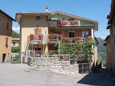 a large house with a fence in front of it at Casa Bruna Tignale in Tignale