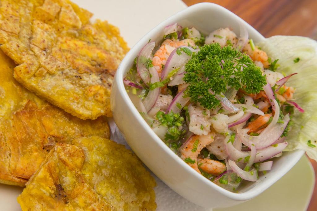 a bowl of salad with shrimp and other foods at Makao Beach Hotel in Palomino