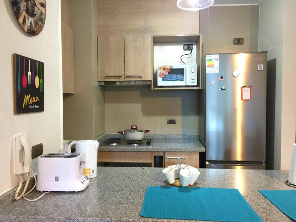 Kuchyň nebo kuchyňský kout v ubytování Apart Hotel R&P Depto A