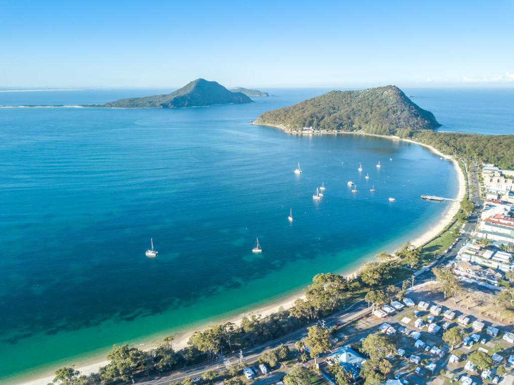 an aerial view of a beach with boats in the water at Shoal Bay Holiday Park in Shoal Bay