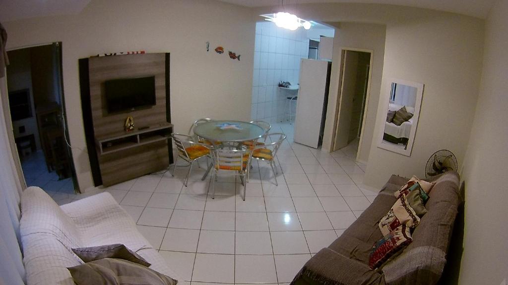 a living room with a couch and a table at Apartamento Guaratuba in Guaratuba