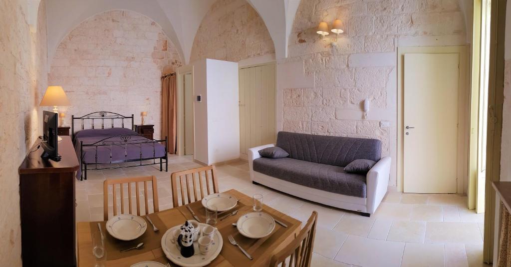 a living room with a table and a couch at Una volta a Martina in Martina Franca