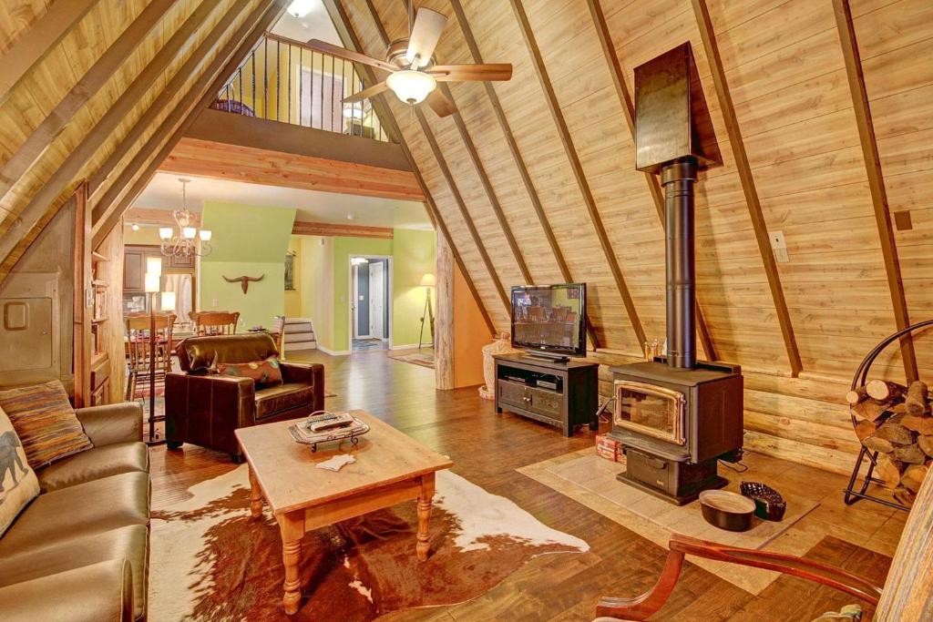 a living room with a couch and a stove at Spruce Creek Lodge Home in Breckenridge