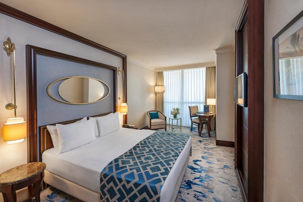 a hotel room with a bed and a mirror at Elite World Istanbul Taksim in Istanbul