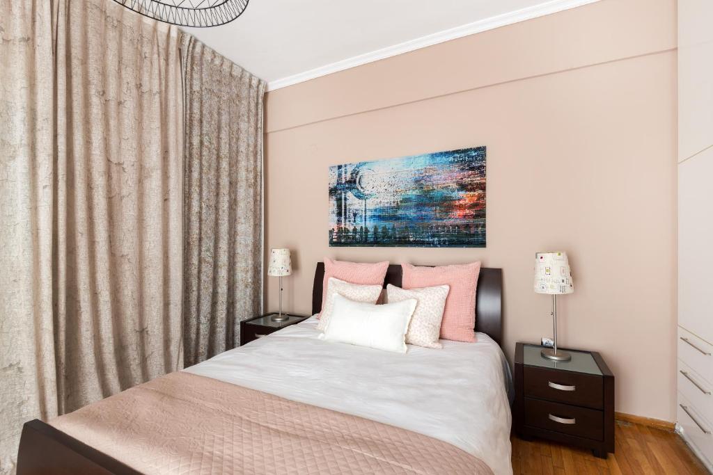 A bed or beds in a room at Acropolis Stylish Suite