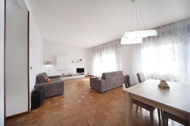 a living room with a table and a dining room at Hotel del Mar in Sottomarina