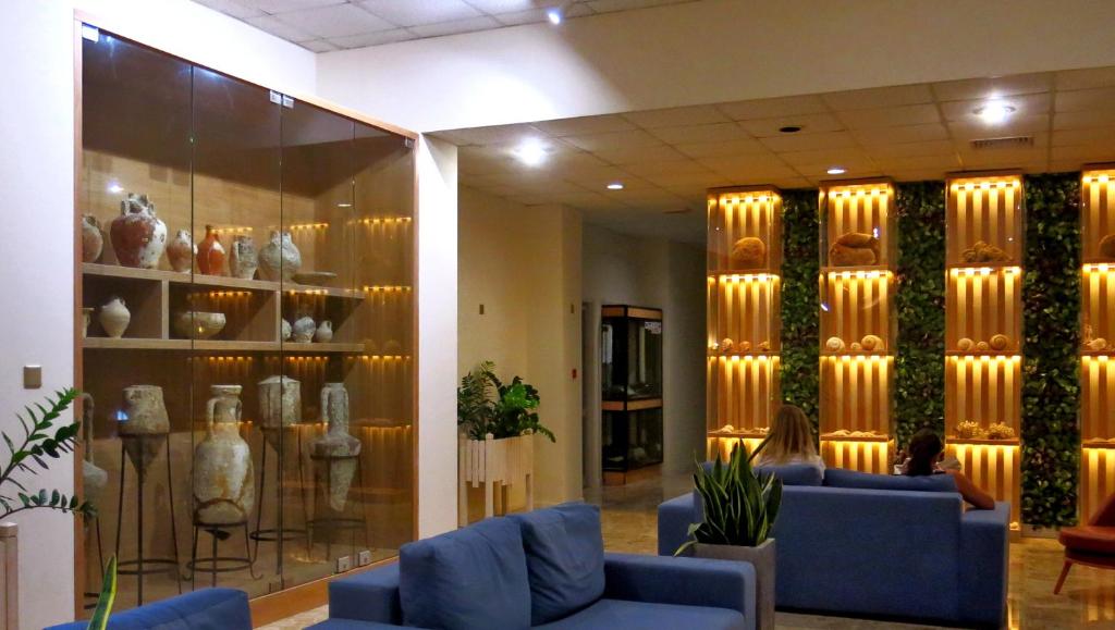 a lobby with couches and vases on display at Marina Hotel in Ayia Napa