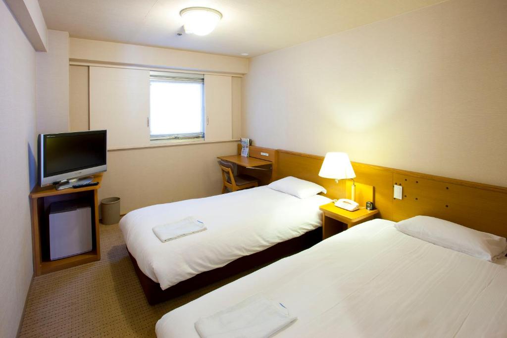 Postel nebo postele na pokoji v ubytování Pearl Hotel Ryogoku