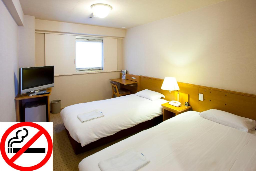 Postel nebo postele na pokoji v ubytování Pearl Hotel Ryogoku