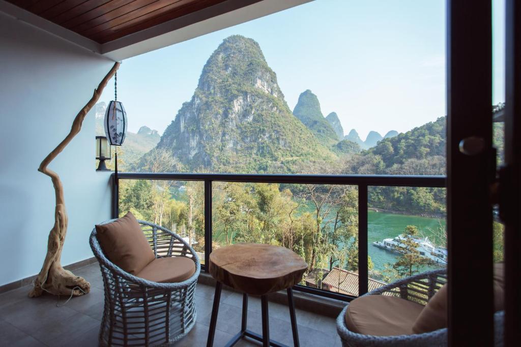 a room with a view of a mountain at Li River Resort in Yangshuo