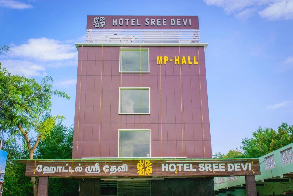 a pink building with a clock on top of it at Hotel Sree Devi Madurai in Madurai