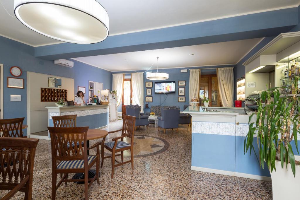 a living room filled with furniture and a kitchen at Hotel & Terme Bagni di Lucca in Bagni di Lucca