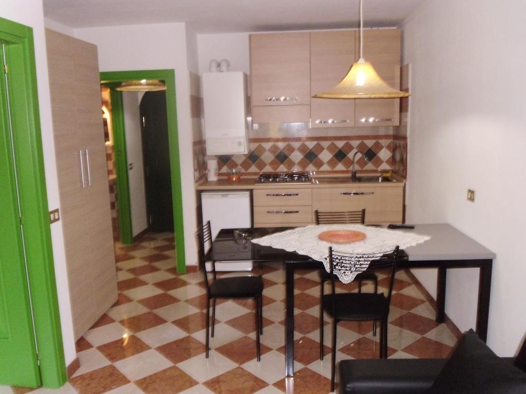 cocina con mesa y sillas en una habitación en Residenza Graziella, en Cavedago