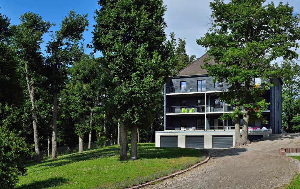 a house on a hill with trees in front of it at Cottage 1956 - Maison d'hôtes in Trois-Épis