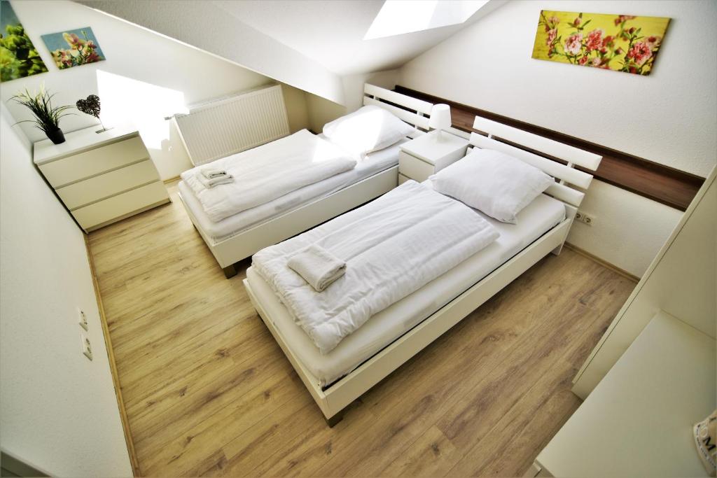 a small room with two beds in it at Exclusive Apartment Cologne in Cologne