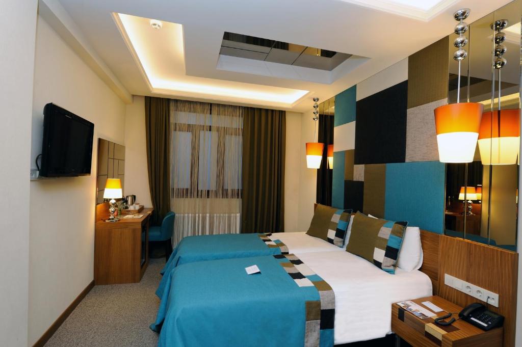 Postel nebo postele na pokoji v ubytování Collage Pera Hotel