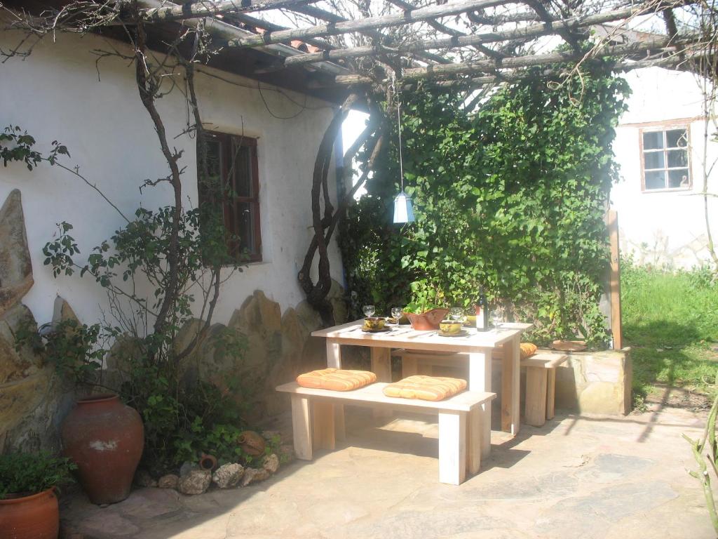 a patio with two tables and a pergola at Monte da Gravita in Ribeira do Salto